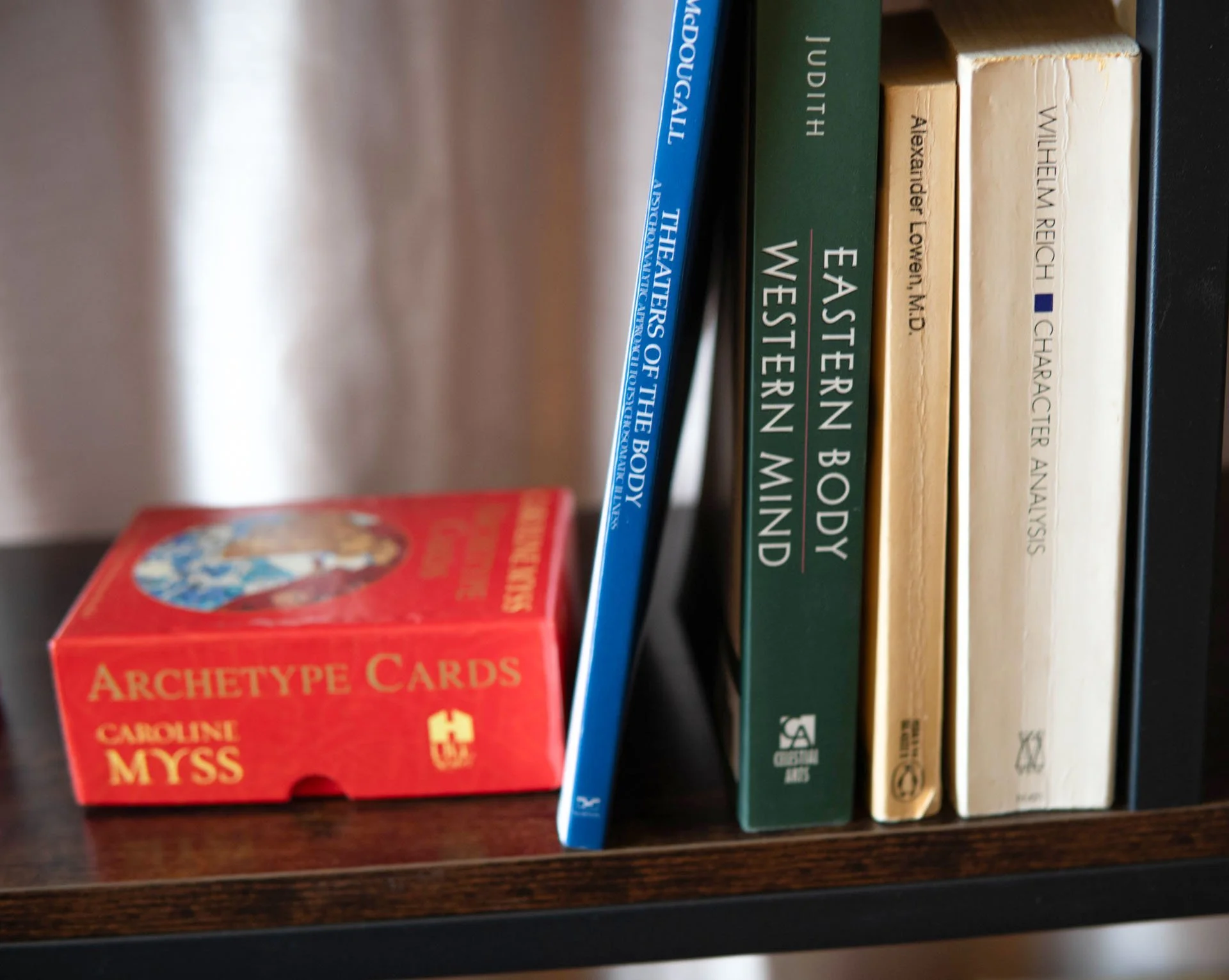 Books on the shelf related to emotional wellness